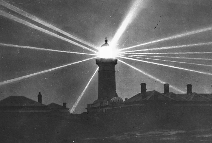 Historic black and white image of Macquarie Lighthouse with it's lights on in 1909.