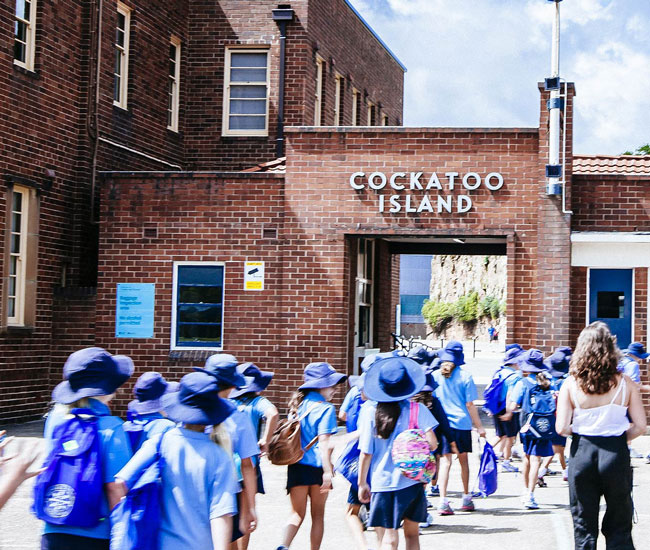 A primary school group entering Cockatoo Island with their teacher to start their education program.